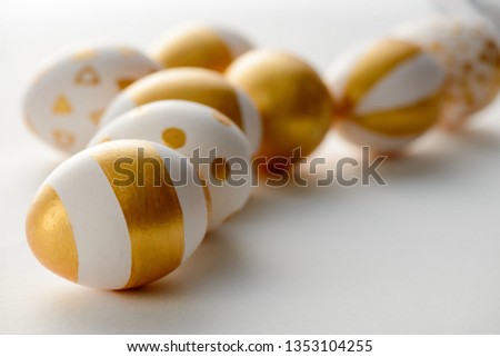 Golden eggs on white background