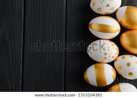 Golden eggs on black background