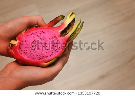 Hands holding dragon fruit