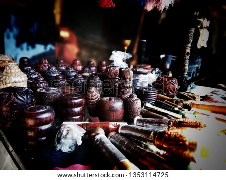 Dark brown wooden chilams are being sold in the Indian city of Rishikesh. Wooden ash trays are lined up in the street markets. Hand made wooden items of Buddha shaped are being sold in Rishikesh,India