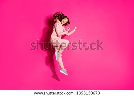 Full length body size photo jump high amazing  party lady hands arms fists raised great flexibility wearing casual pink costume suit pullover outfit isolated bright vibrant rose background