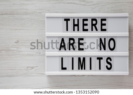 Modern board with 'There are no limits' words on a white wooden surface, top view. Flat lay, overhead. Copy space.