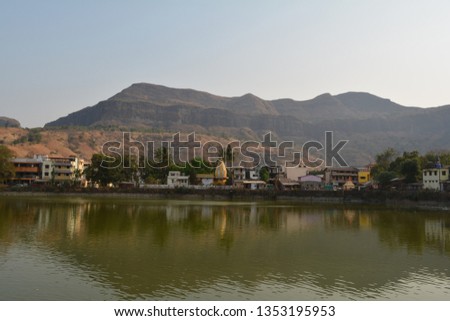 landscape photography containing hills and lake
