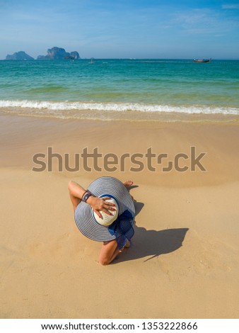 Woman enjoying her holidays at the tropical beach in Thailand - UNRETOUCHED body.