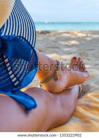 Legs of a woman at the beach