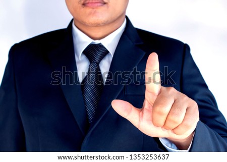 Business man with pointing to something or touching a touch screen on white background.