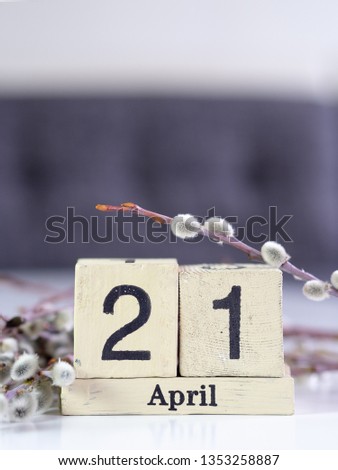 Easter concept with square shaped wooden calendar and pussy willow. April 21, 2019. 