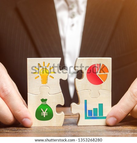 Businessman collects puzzles with the image of the attributes of doing business. Strategy planning concept. Organization of the process. Creating a business model. Management. Research, marketing.