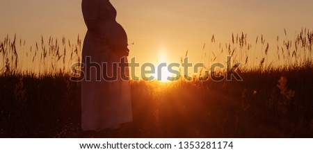 pregnant women at sunset