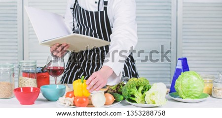 Culinary arts concept. Improve cooking skill. Ultimate cooking guide for beginners. Book family recipes. According to recipe. Man bearded chef cooking food. Guy read book recipes. Man learn recipe.
