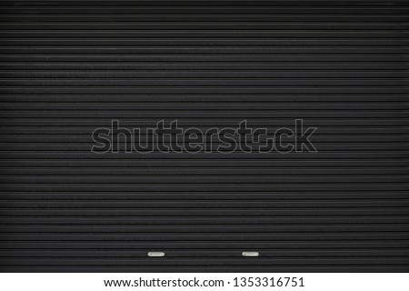black shutter door with stainless steel holder. grunge black metal foldable door background and texture. Royalty-Free Stock Photo #1353316751