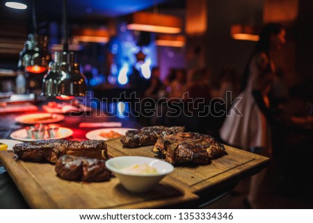 Juicy and appetizing steaks on the grill. The cooking process and a great picture for the restaurant.