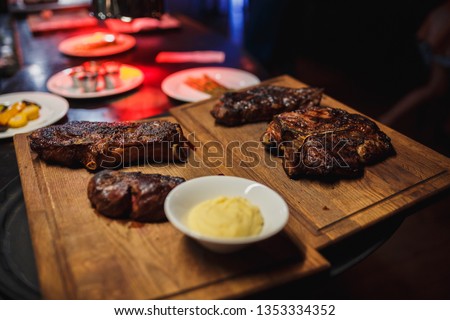 Juicy and appetizing steaks on the grill. The cooking process and a great picture for the restaurant.