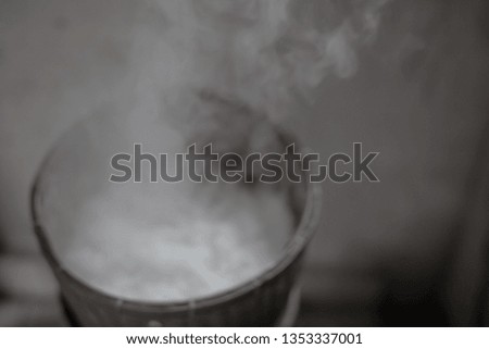 Steaming glutinous rice with smoke in countryside kitchen of Thailand. blurred picture