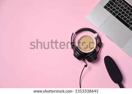 Music or podcast background with headphones, microphone, coffee and laptop on pink table, flat lay. Top view, flat lay