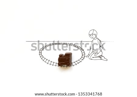 Hand drawing cute cartoon child playing with chocolate train toy. Minimal, creative or food art concept. Copy space