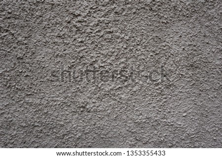 Rough textured and painted light brown stone wall