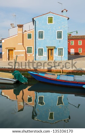 The multicolored houses on the shore of a narrow channel - Burano, Venice, Italy