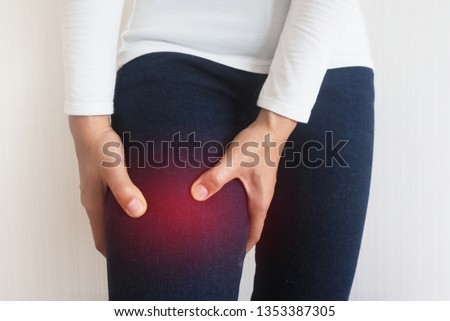Thigh pain or muscle twitching or muscle cramp in asian woman with isolated on white background using for health care concept. Royalty-Free Stock Photo #1353387305