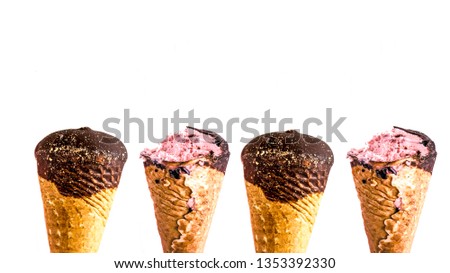 Chocolate ice cream horns. Ice cream in a waffle cone in chocolate glaze, bitten off and a whole ice cream cone Top view, copy space. Isolate