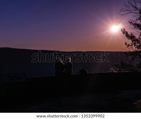 Couple sitting on wall