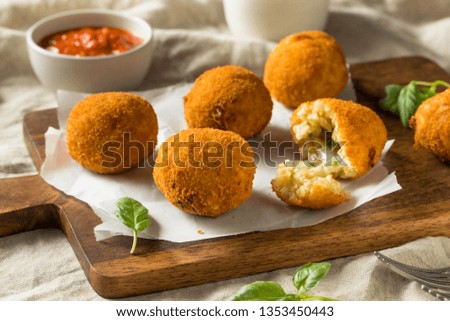 Homemade Deep Fried Risotto Arancini with Basil and Marinara Royalty-Free Stock Photo #1353450443