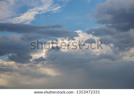 Beautiful pink and gray clouds on azure blue sky at sunset time. Pastel and bright shades of natural colors in the sky. High dynamic range, contrast sight, sky blue gamma. Nephology, meteorology.