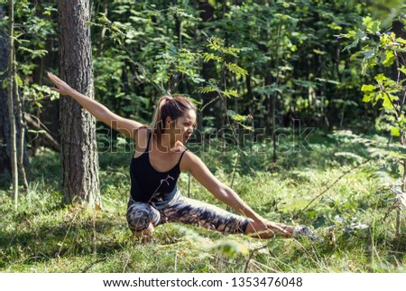 Kung fu girl training in the forest. A cute female practicing martial arts in the park.  Royalty-Free Stock Photo #1353476048