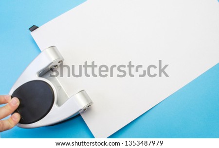 Hole Punch Makes Holes In Blank Sheet Of Paper