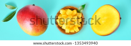 Fresh cut mango health product with leaf on blue background. Mangos wide banner or panorama fruit concept top view.