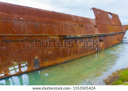 Scuttled rusting hulk of old ship Waverley in shallows of Wairau Lagoons on nature walk. Royalty-Free Stock Photo #1353505424
