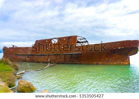 Scuttled rusting hulk of old ship Waverley in shallows of Wairau Lagoons on nature walk. Royalty-Free Stock Photo #1353505427