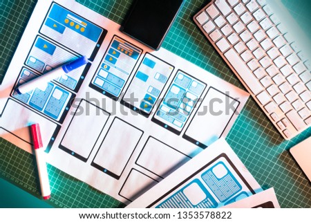 Workplace graphic designer. Table with keyboard. Outline an application for mobile devices. Website design development. Tablet applications.