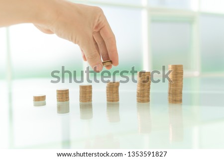close up. businessman stacking coins on office Desk