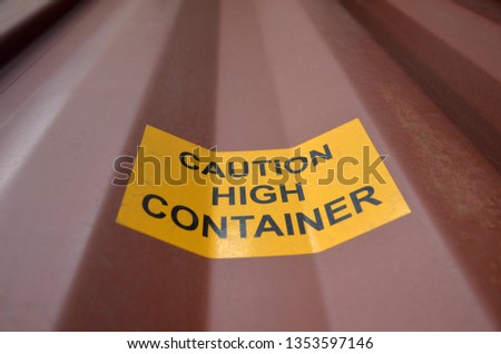 Sign caution high container on a red Container