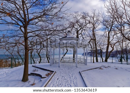 Gazebo in Lakewood Park, Ohio, in winter with Cleveland skyline
