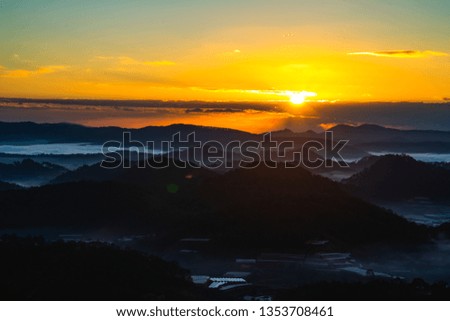 Sunrise behind mountain and clouds