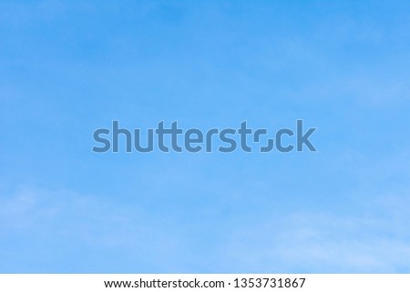 Beautiful, abstract, blue sky background. There are feathery clouds in the sky. The texture on which you can place the text or advertising.