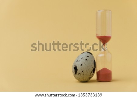 egg and sandglass. growing up concept