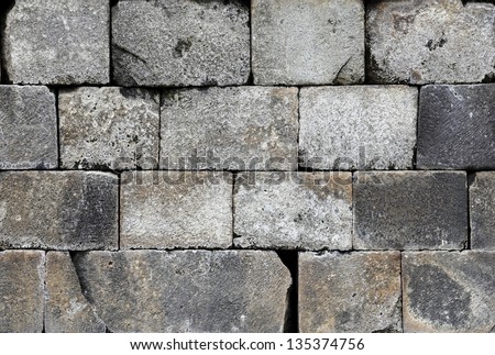 Ancient sandstone cinder block wall for textural background.