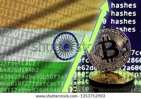 India flag and rising green arrow on bitcoin mining screen and two physical golden bitcoins