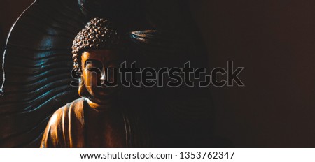 Golden Gautama Buddha statue with a black background depicting darkness and hope coming in form of sunlight. Thank you for downloading this image. 