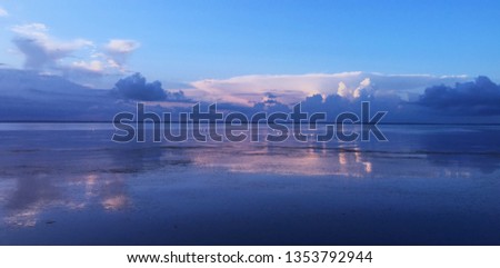 Sunset with dramatic sky and swans  on the black sea (lyman), Kinburn, Ukraine