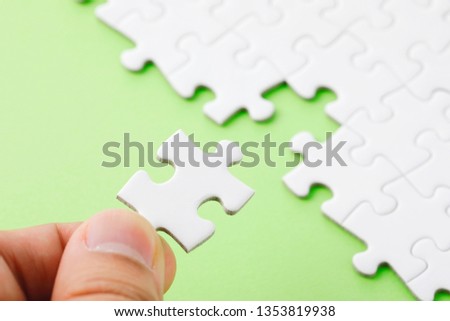 White jigsaw puzzle on green background
