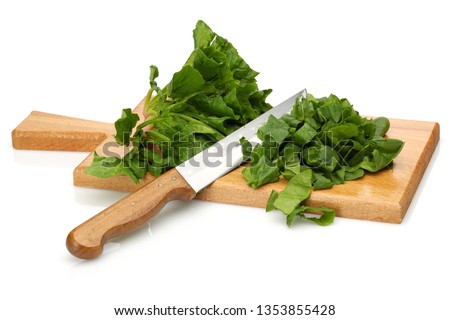Chopped spinach and knife on wooden board isolated white background Royalty-Free Stock Photo #1353855428