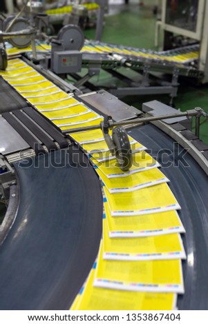 Newspaper production and printing process. The conveyor with magazines. Printing factory. A stream of journal production.