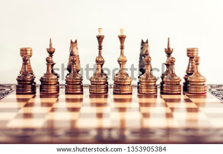 Wooden chess pieces on a chessboard, leadership concept on white background