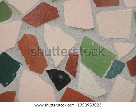 Texture of small ceramic tiles of various shapes and colors. Background of a mosaic. sovit color mosaic texture.  Detail of old antique mosaic with colored glass on wall of destroyed building