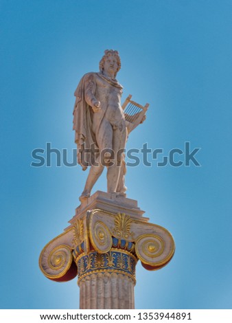 Apollo the ancient god of music and poetry marble statue under blue sky background, Athens Greece