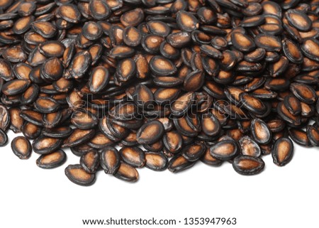Macro group of watermelon seeds on white background.